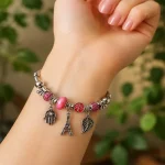 بنگل پاندورا دخترانه مهره‌ای صورتی با آویزهای فانتزی و طراحی خاص